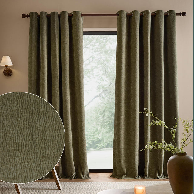 Heath washed velvet eyelet curtains in eucalyptus green hanging fully lined either side of a window, with a fabric texture swatch shown in a living room setting.