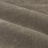 Close-up of Heath eyelet curtains in greige, showing the washed velvet jacquard fabric with a crumpled, textured surface and soft folds.