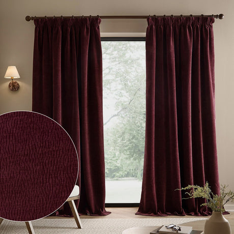 Heath washed velvet pencil pleat curtains in beetroot red hung on a dark pole beside a window, shown in a living room with a fabric texture swatch inset.