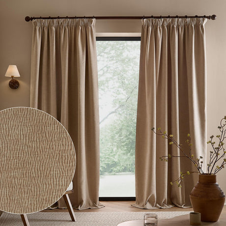 Heath washed velvet pencil pleat curtains in linen beige, hung on a dark pole in a living room, with a fabric swatch showing the textured jacquard weave.