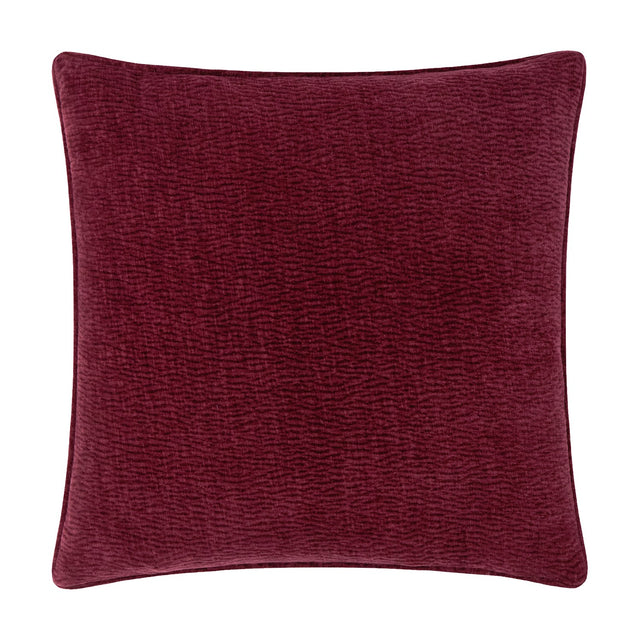 Heath square cushion in deep beetroot red washed velvet with a jacquard-textured surface and piped edge, shown on a plain white background.