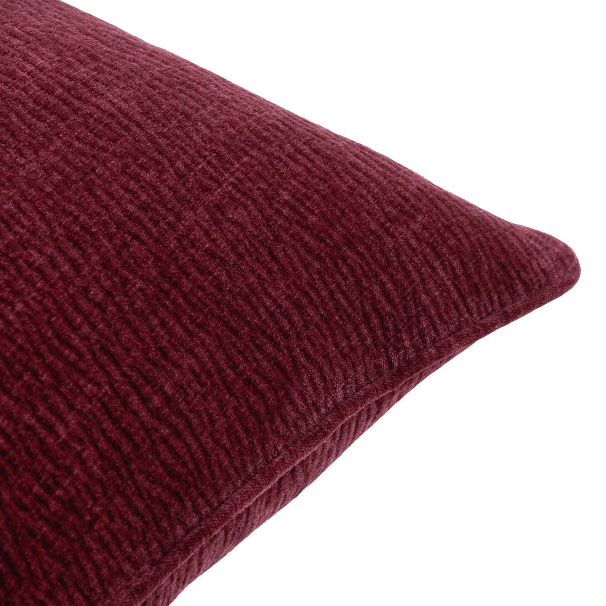 Close-up of the Heath washed velvet jacquard cushion in beetroot red, showing its textured, ribbed surface and stitched edge seam on a white background.