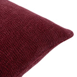 Close-up of the Heath washed velvet jacquard cushion in beetroot red, showing its textured, ribbed surface and stitched edge seam on a white background.