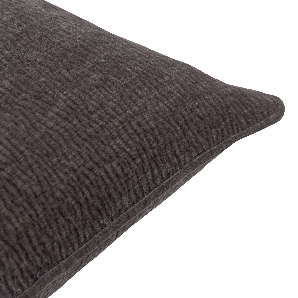Close-up corner view of the Heath washed velvet jacquard cushion in charcoal, showing textured fabric and piped edge against a white background.