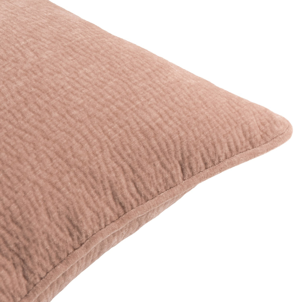 Close-up of the Heath cushion in Cotta dusky pink, showing enzyme-washed velvet jacquard texture and a piped edge, on a plain white background.