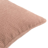 Close-up of the Heath cushion in Cotta dusky pink, showing enzyme-washed velvet jacquard texture and a piped edge, on a plain white background.