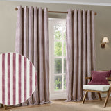Hebden Cotton Fully Lined Eyelet Curtains in Beetroot, a pair with vertical red and cream stripes and metal grommets, shown framing a window in a living room setting.