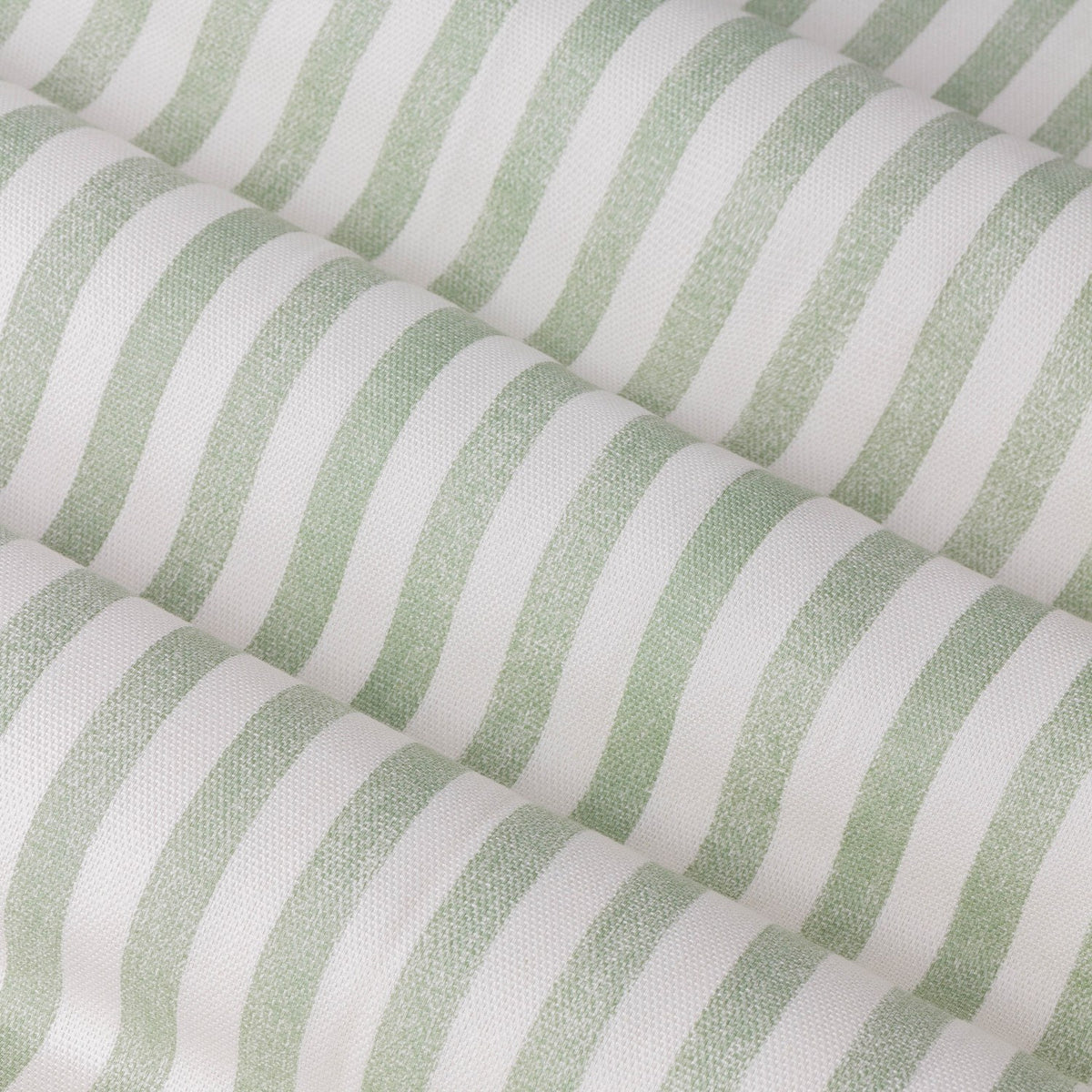 Close-up of the Hebden Cotton Fully Lined Eyelet Curtains in Eucalyptus, showing narrow vertical green stripes on a cream cotton ground with a soft woven texture.