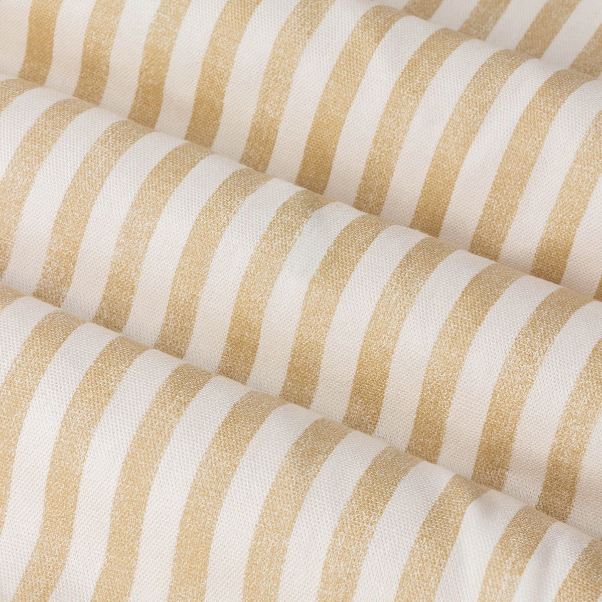 Close-up of Hebden Eyelet Curtains in 100% cotton, showing soft folds with a honey yellow vertical stripe woven against an off-white ground.