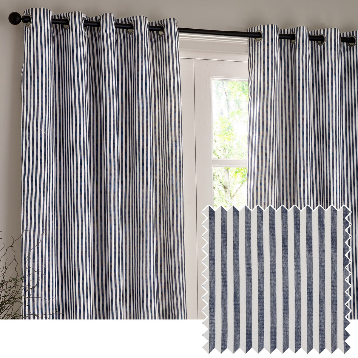 Hebden Cotton Lined Eyelet Curtains in navy and white vertical stripe, hung on a black eyelet rod beside a glass door, with a folded fabric swatch shown below.