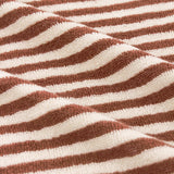 Close-up of the Hebden Striped Cotton Bath Mat in pecan brown and cream, showing woven cotton terry texture with vertical stripes.