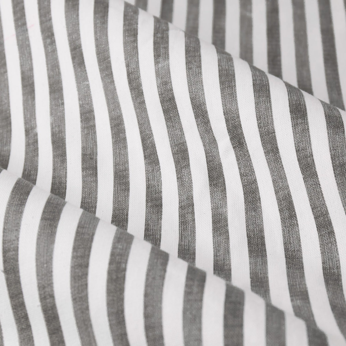 Close-up of Hebden Pencil Pleat Curtains in grey, showing a vertical grey-and-white striped cotton fabric with a soft, slightly slubbed ticking-style texture.