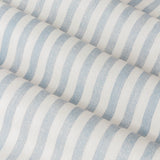 Close-up of Hebden pencil pleat curtain fabric in mineral blue, showing woven cotton with narrow vertical stripes on a pale ground and soft folds.