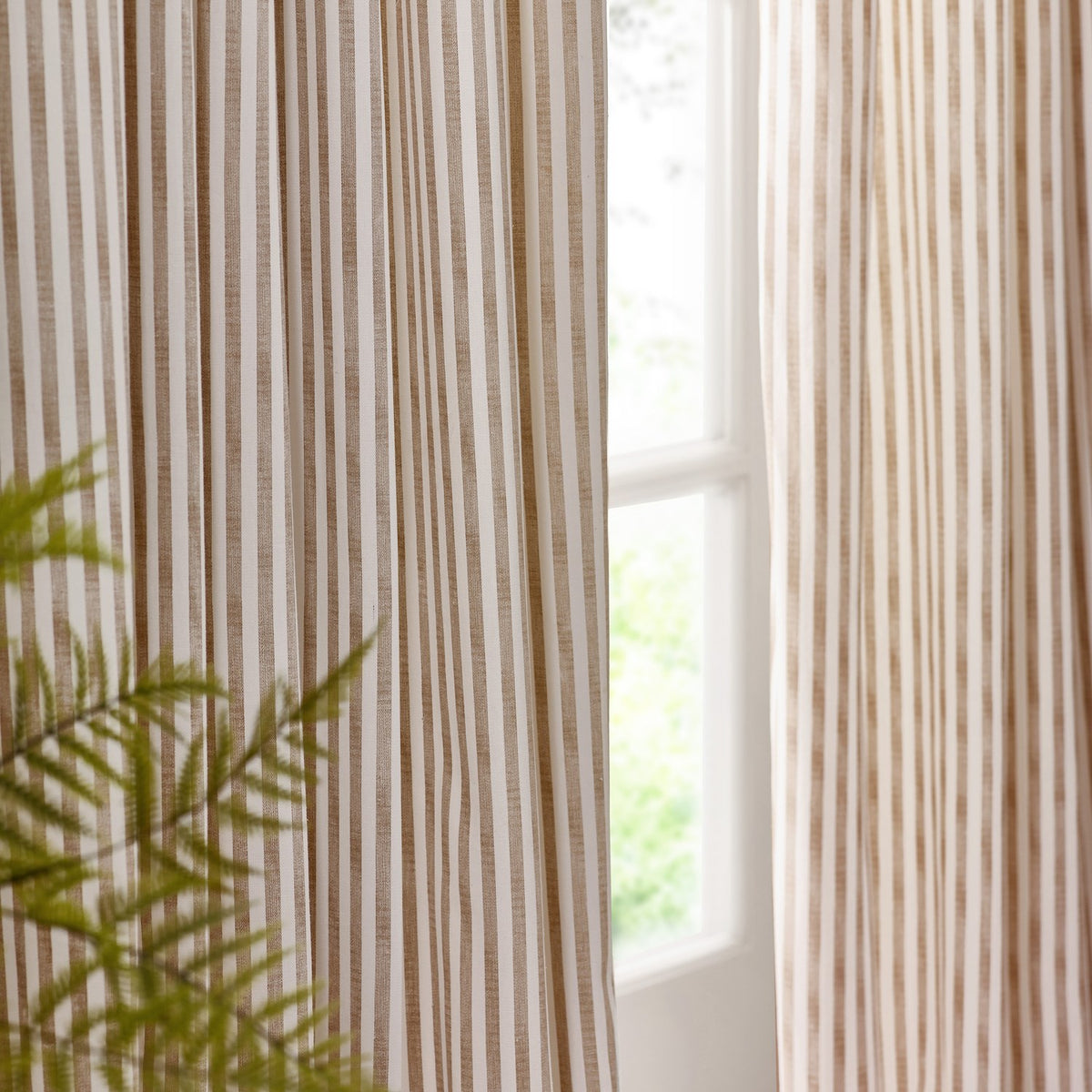 Hebden Striped Cotton Pencil Pleat Curtains in natural beige and off-white, shown hanging pencil pleat panels beside a window with soft daylight.