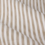 Close-up of Hebden pencil pleat curtain fabric in natural beige, showing woven cotton with a vertical stripe pattern against an off-white ground.