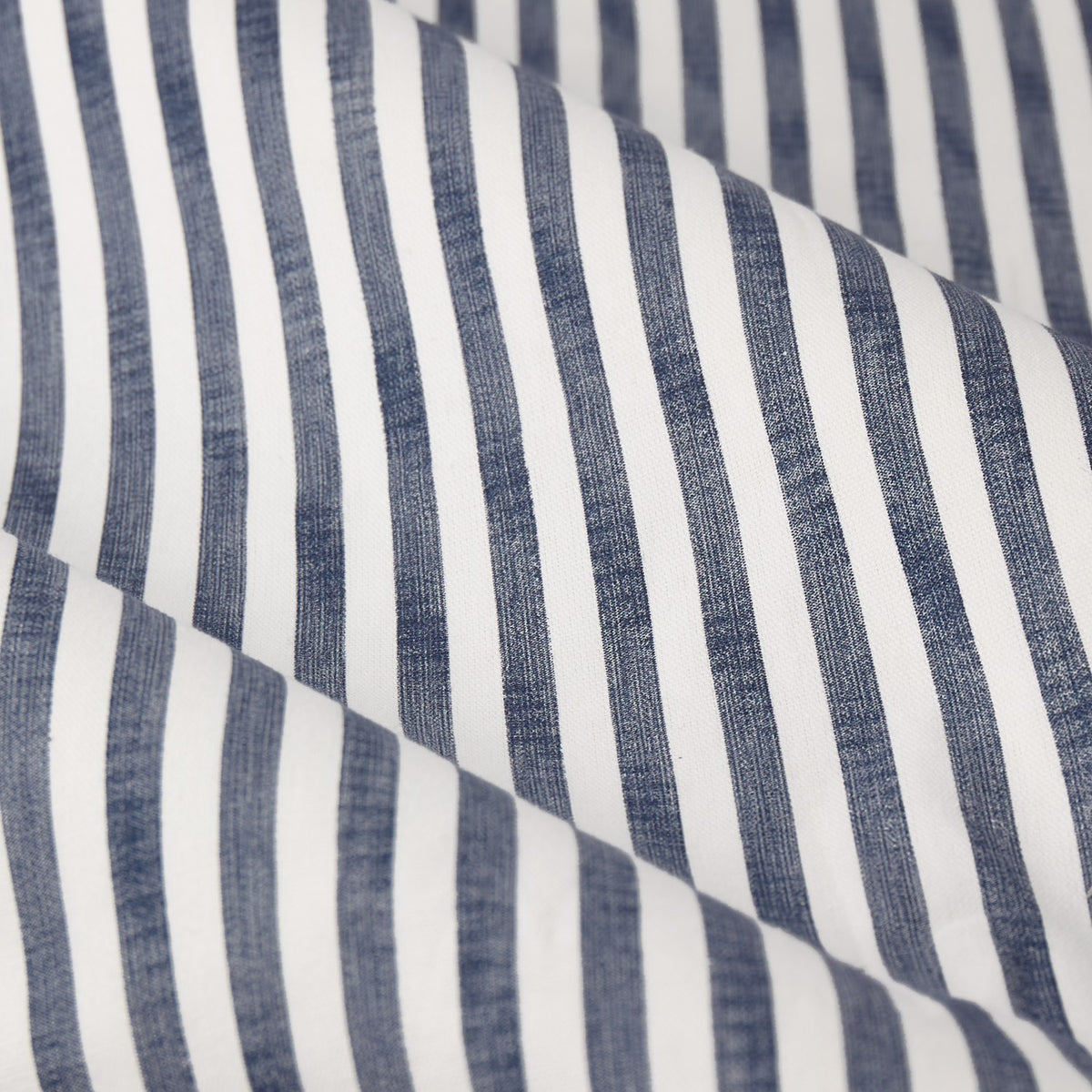 Close-up of Hebden Pencil Pleat Curtains fabric in navy and white ticking stripe, 100% cotton with a soft, vertical striped weave.