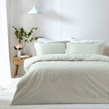 Hebden Cotton Striped Duvet Cover Set in Eucalyptus, showing a green and white striped cotton duvet with matching pillowcases on a bed in a bedroom setting.