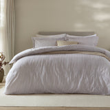 Hebden Cotton Melange Duvet Cover Set in mauve, styled on a bed with fine mauve-and-white striped cover and matching pillowcases in a neutral bedroom setting.