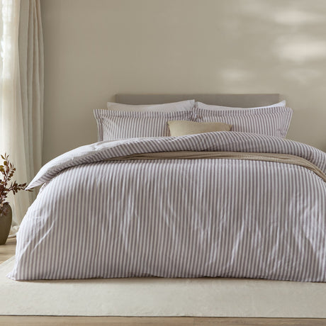 Hebden Cotton Melange Duvet Cover Set in mauve, styled on a bed with fine mauve-and-white striped cover and matching pillowcases in a neutral bedroom setting.