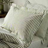 Hebden Cotton Melange Duvet Cover Set in olive green striped cotton, shown styled on a bed with matching pillowcases in a bedroom setting.