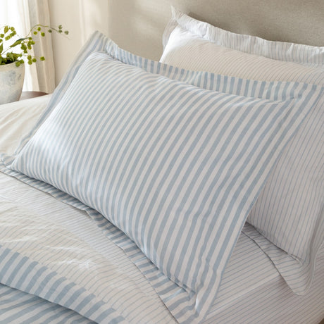 Hebden Melange Cotton Pillowcase Pair in Mineral Blue, striped pillowcases with matching pillow sham and duvet, styled on a bed in a neutral bedroom setting.