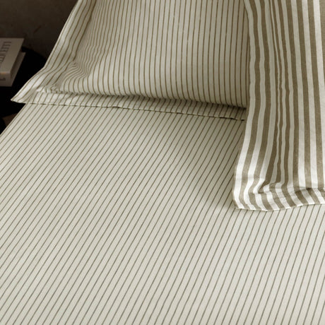Hebden Striped Cotton Fitted Sheet in mole, made up on a bed with matching pillowcase, showing fine taupe-grey pinstripes on a cream cotton ground.