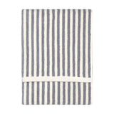Folded Hebden cotton terry towel with vertical grey and cream stripes and a white woven trim, shown on a plain white background.