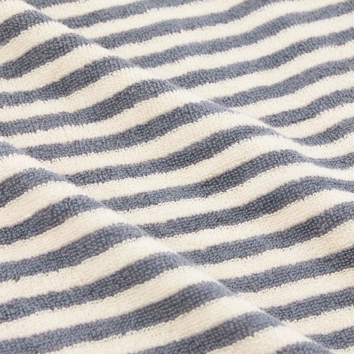 Close-up of Hebden Striped Cotton Towels in mineral blue, showing woven terry cloth with even vertical stripes against a cream ground.