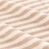 Close-up of the Hebden Striped Cotton Towel in natural, showing vertical beige and cream stripes on soft cotton terry fabric.