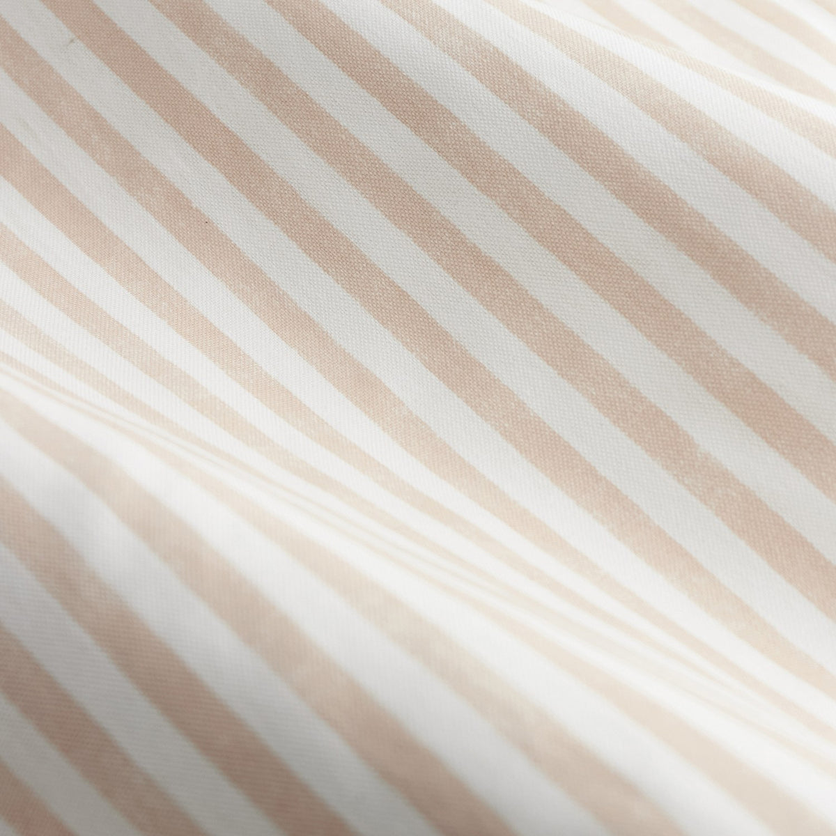 Close-up of Hebden Cotton Printed Eyelet Curtains in blush, showing a diagonal woven-look stripe pattern in blush and off-white on lightweight cotton fabric.