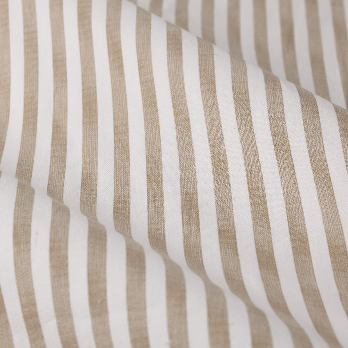 Close-up of Hebden Cotton Printed Eyelet Curtains in natural, showing a fine beige stripe pattern on an off-white cotton fabric with soft folds.