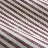 Close-up of Hebden Pencil Pleat Curtains fabric in cotton with a printed beetroot red and cream diagonal stripe pattern, shown draped to reveal texture and folds.
