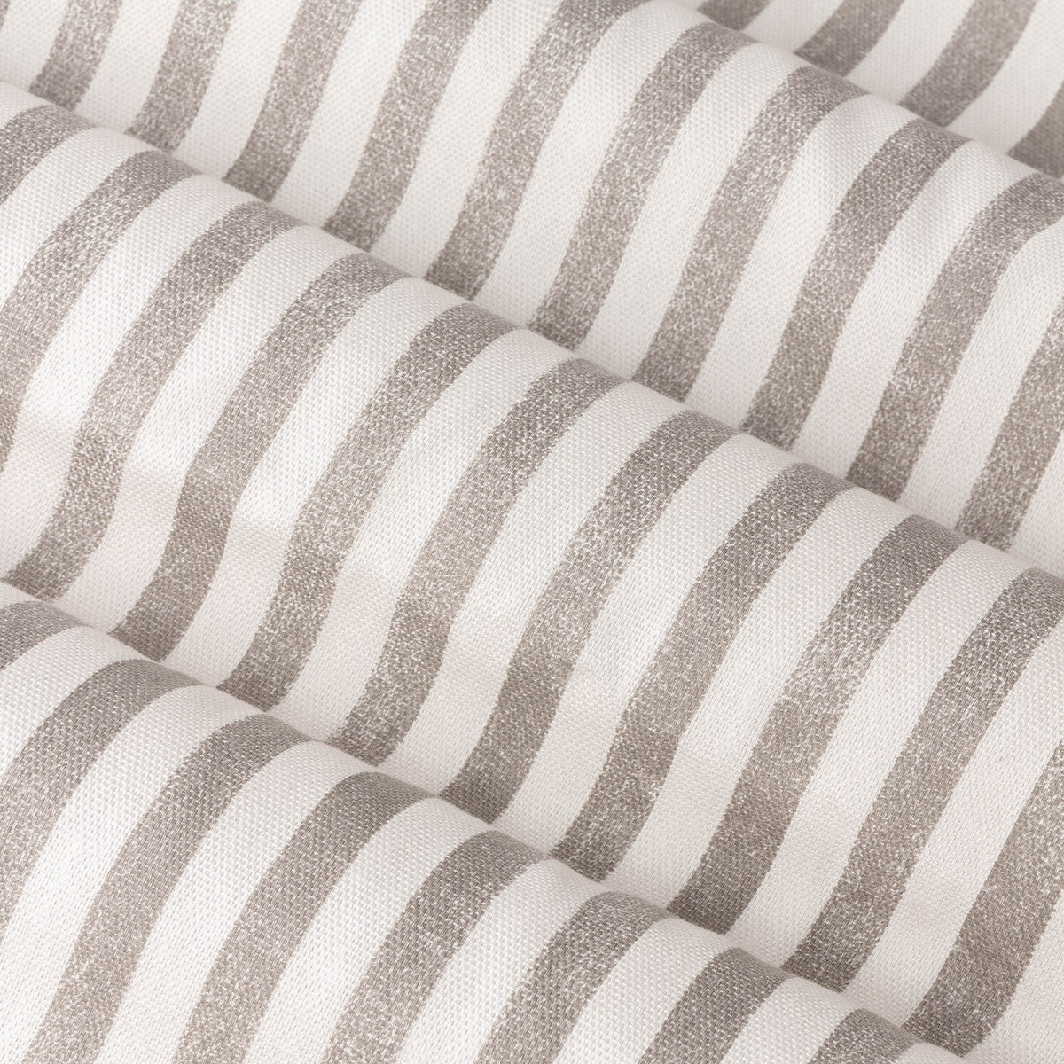 Close-up of Hebden Pencil Pleat Curtains fabric in mole, showing a fine woven brown stripe pattern on cotton against a pale ground with soft draped folds.