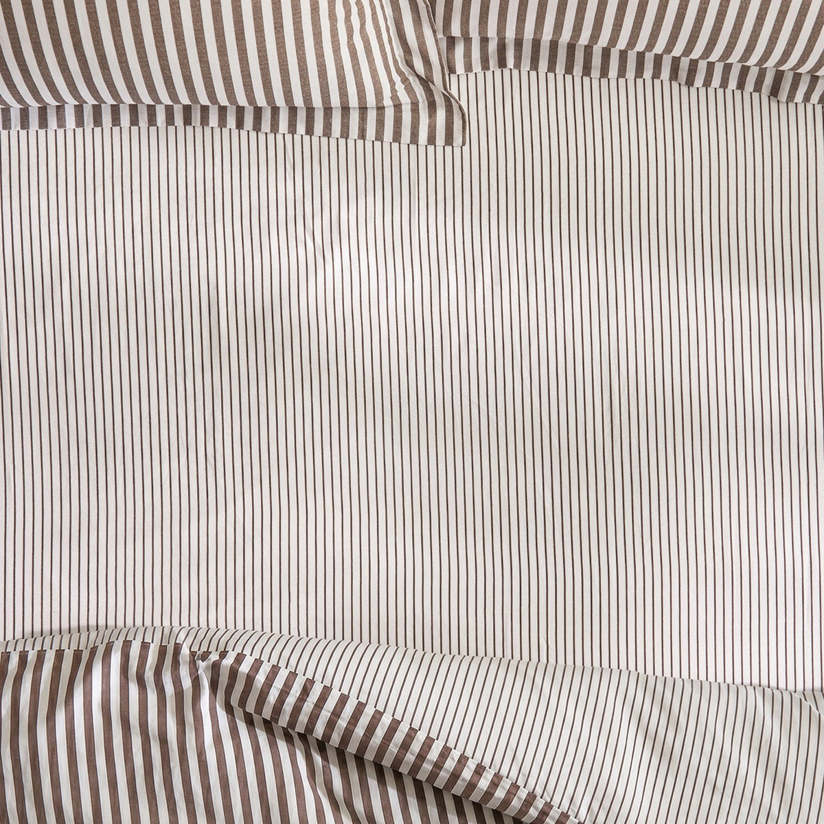 Hebden Striped Cotton Fitted Sheet in Espresso Brown, close-up of pure cotton fabric with narrow brown pinstripes on an off-white ground and elasticated corner detail.
