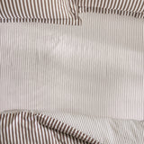 Hebden Striped Cotton Fitted Sheet in Espresso Brown, close-up of pure cotton fabric with narrow brown pinstripes on an off-white ground and elasticated corner detail.