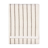 Folded Hebden Striped Cotton Towel in cream with narrow mole brown vertical stripes and a plain woven border, shown on a white background.