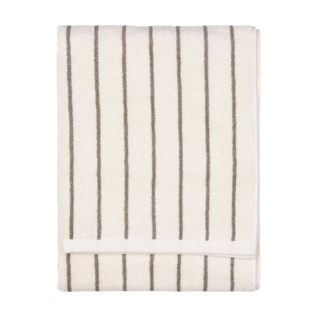 Folded Hebden Striped Cotton Towel in cream with narrow mole brown vertical stripes and a plain woven border, shown on a white background.