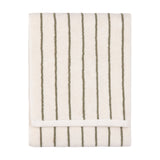Folded Hebden cotton towel in cream with narrow olive-green vertical stripes and visible terry pile, shown on a plain white background.