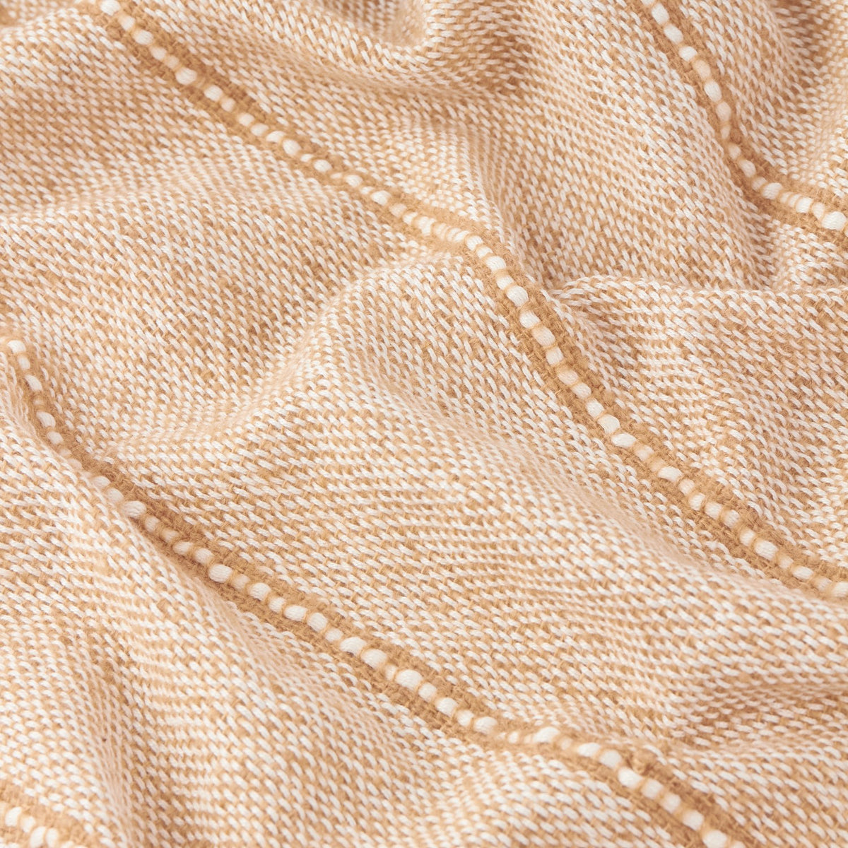 Close-up of the Hedon Striped Polyester Throw in natural, showing a woven sand-toned fabric with fine cream flecks and a subtle linear stripe pattern.