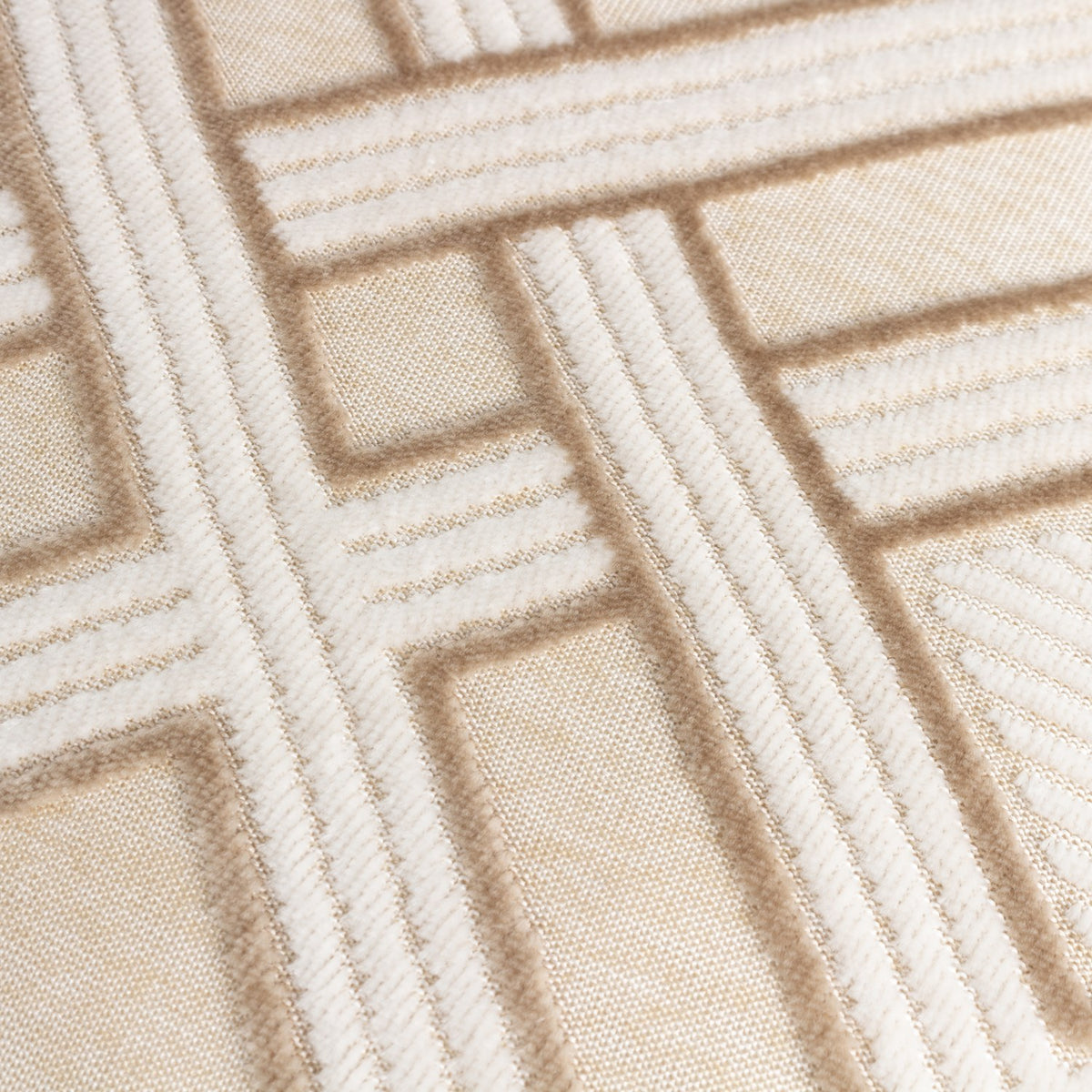 Close-up of the Henley Jacquard Velvet Cushion in warm taupe, showing raised geometric lattice pattern in off-white against a soft taupe velvet ground.