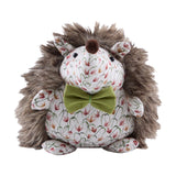 Henrietta Polyester Door Stop shaped like a hedgehog with shaggy brown faux fur back, cream floral fabric face and belly, a pom-pom nose, and an olive-green bow, on a plain white background.
