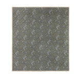 Hermione Linen Cotton Bedspread in Moss, a quilted throw-over with cream and blue Toile de Jouy floral print, finished with a cream ruffled frill edge on a plain background.