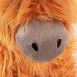 Close-up of the Highland Cow Velvet Faux Fur Door Stop in orange, showing shaggy fur fringe framing a grey velvet snout with embroidered black nostrils.