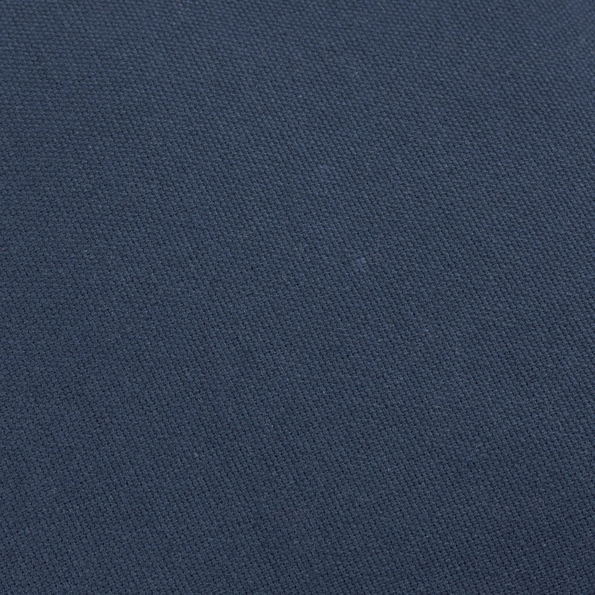 Close-up of the Holmfirth cushion's navy cotton canvas fabric, showing its tightly woven, textured surface.