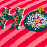 Close-up of the HoHoHo Abstract Velvet Cushion in red, showing embroidered "HO" lettering and a bauble motif on a red and pink candy-striped velvet ground.