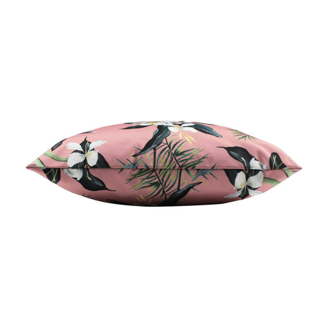 Honolulu Floral Polyester Cushion in pink, shown edge-on, with a tropical print of white blooms, dark leaves and palm fronds on a square cushion against a white background.