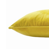 Close-up side view of the Hortus Animal Velvet Cushion in Ceylon, showing yellow velvet fabric with piped edge seam, photographed against a plain white background.