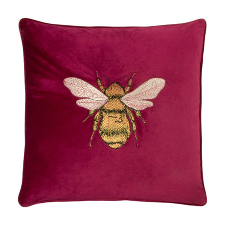 Hortus Animal Velvet Cushion in fuchsia, square with piped edge, featuring a centrally embroidered bee in gold and amber with pale rose wings, shown on a plain white background.