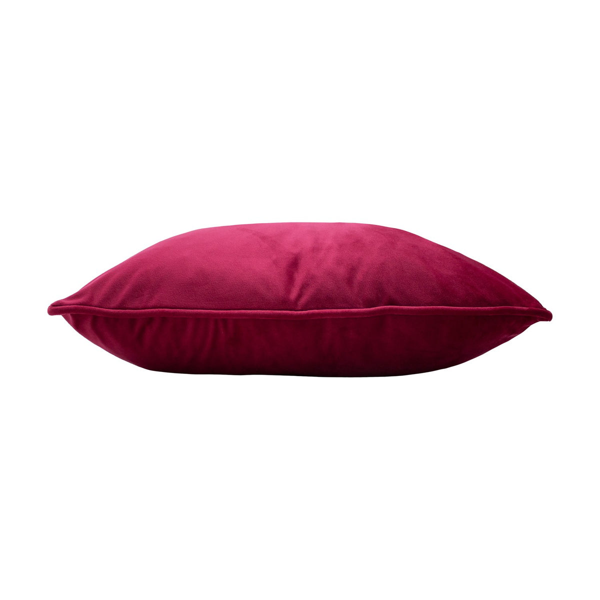 Hortus Animal Velvet Cushion in fuchsia, shown side-on to display its plump velvet pile and piped edge finish, set against a plain white background.