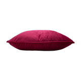 Hortus Animal Velvet Cushion in fuchsia, shown side-on to display its plump velvet pile and piped edge finish, set against a plain white background.